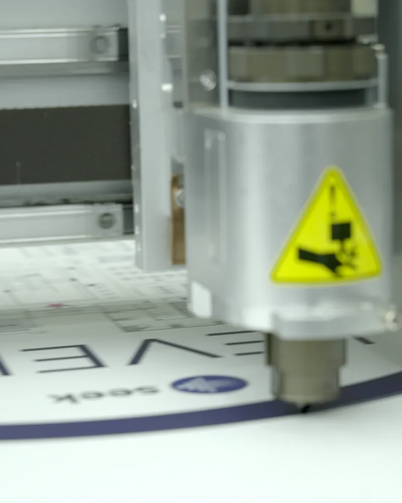 Digital flatbed cutter knife cutting a printed sign to shape