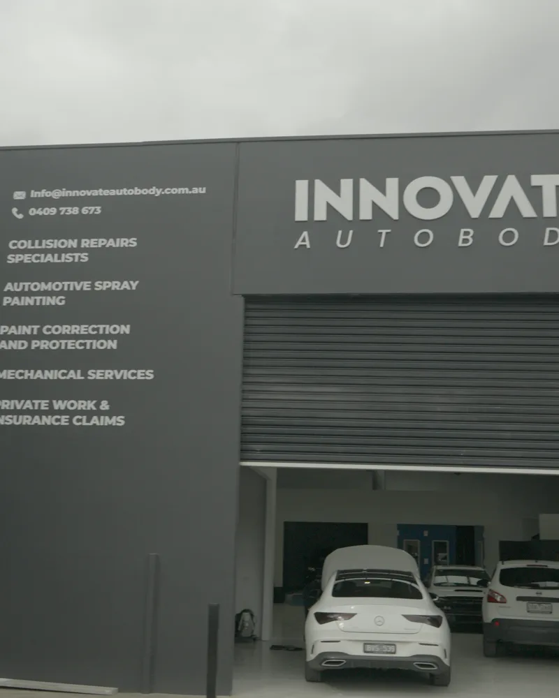 Industrial building with Innovate Autobody fascia signage listing its services